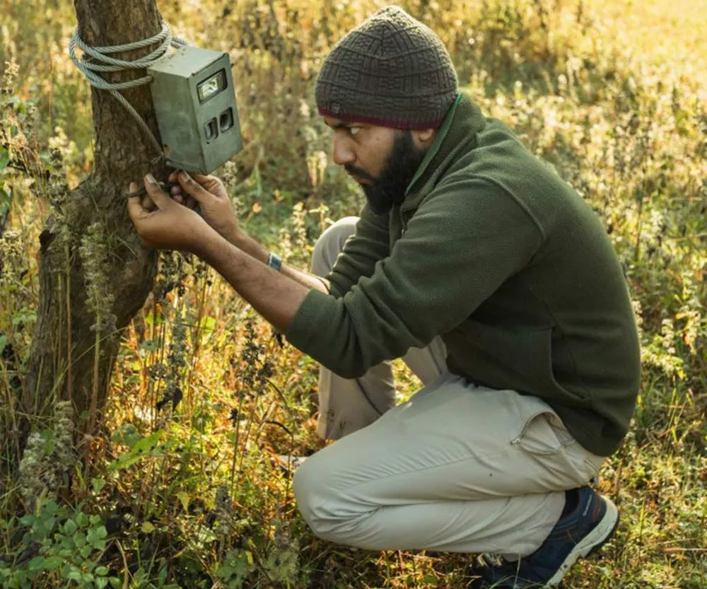 A Naturalist Collecting Data From The Camera Trap