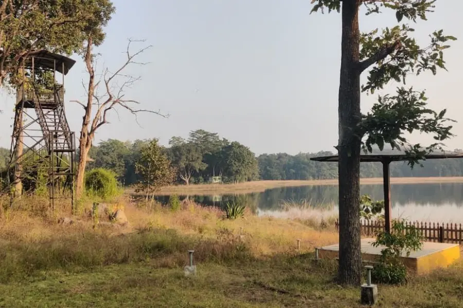 Mogarkasa Lake in Pench, featuring a rustic watchtower and forest-fringed waterbody.